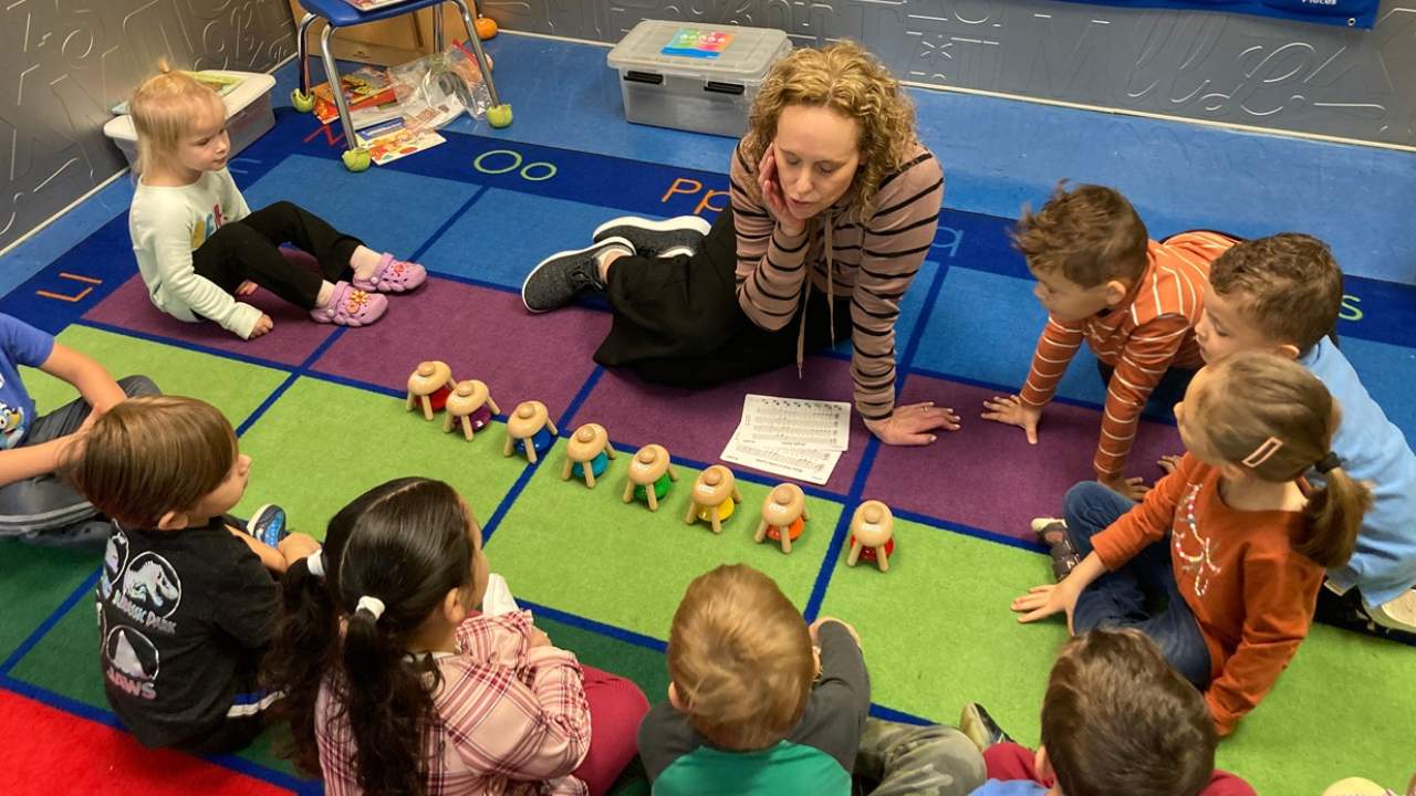 Preschool classroom teacher with students