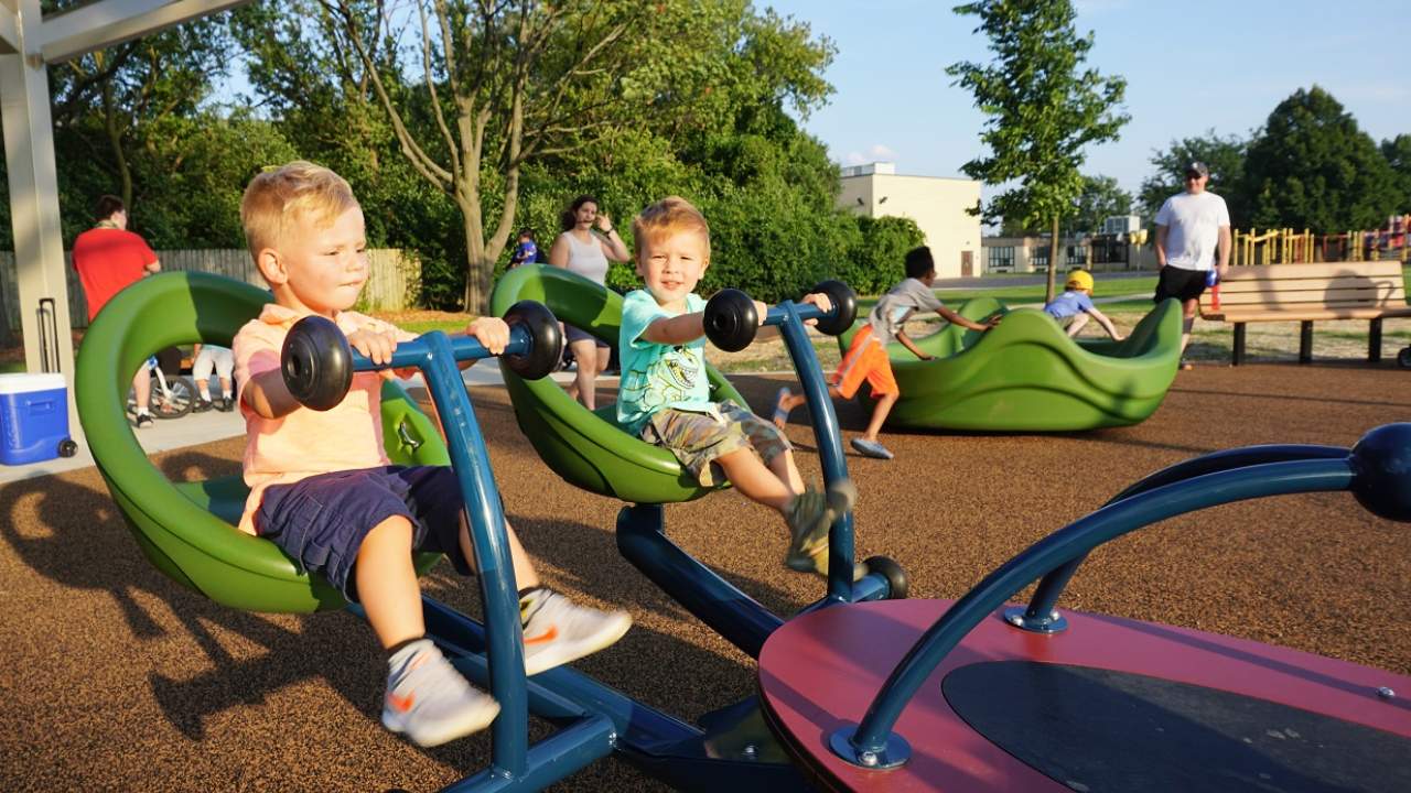 Kids having fun on the seesaw and Conrad Fischer Park, Elmhurst, Illinois