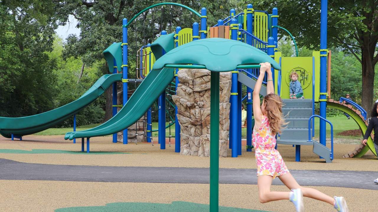 Ribbon cutting celebrates new Ben Allison Park playground, kid playing