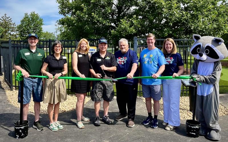 Board Commissioners and Staff stand in front of new mini golf course at The Hub at Berens Park