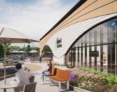 Exterior rendering of a modern building with curved white façade, arched windows, and outdoor seating tables and chairs along a landscaped garden bed