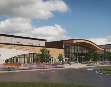 Rendering of exterior view of a modern building with a curved facade and landscaped shrubs, featuring the “Elmhurst Park District” logo and a covered entrance.