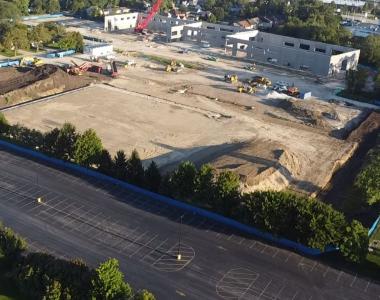 Aerial view of Wagner construction site, surrounded by trees and roads, with equipment.