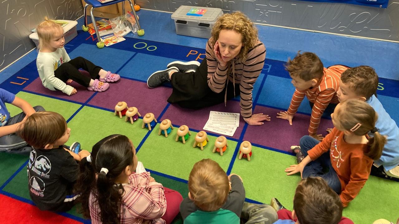Preschool classroom teacher with students