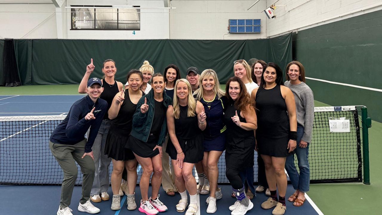 A group of women on a tennis court