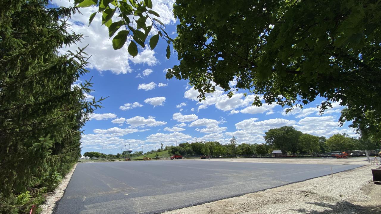 Asphalt installation begins at the tennis courts Asphalt installation at a park